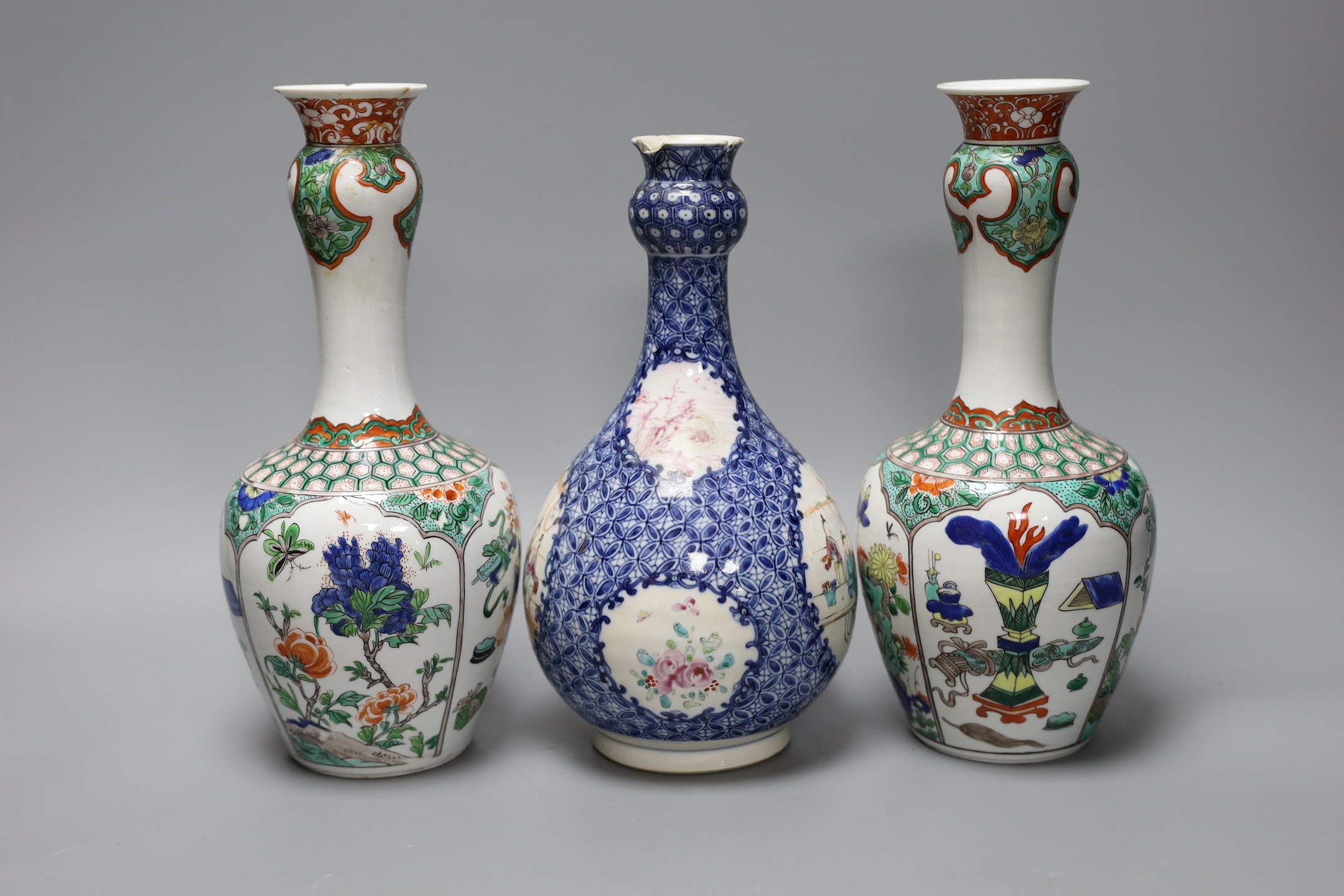 A pair Samson of Paris vases in the Chinese famille verte style and a Chinese Qianlong famille rose garlic neck vase with blue panelling motif, tallest 26cm